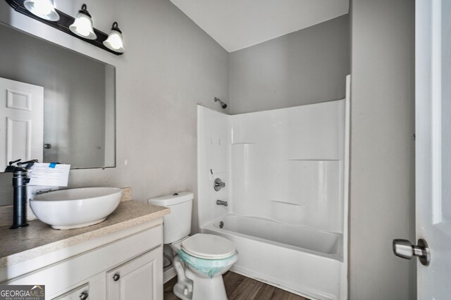 2820 Maxwell Pl, Lithia Springs, GA 30122 - full bath with toilet, vanity, shower / bathing tub combination, and wood finished floors
