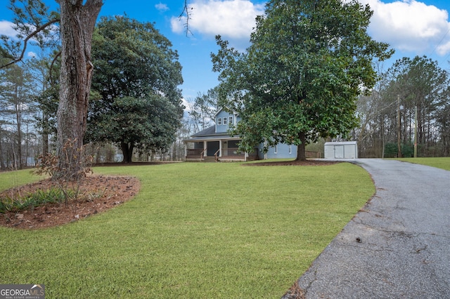 2820 Maxwell Pl, Lithia Springs, GA 30122 - view of front of home with a garage, aphalt driveway, a porch, and a front lawn