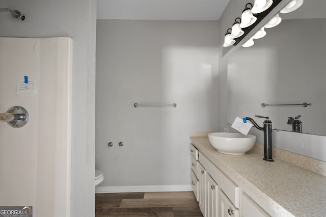 2820 Maxwell Pl, Lithia Springs, GA 30122 - bathroom featuring toilet, vanity, baseboards, and wood finished floors