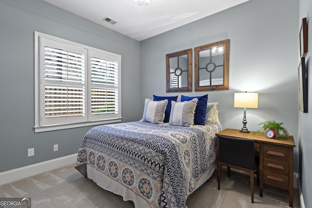 carpeted bedroom with baseboards and visible vents