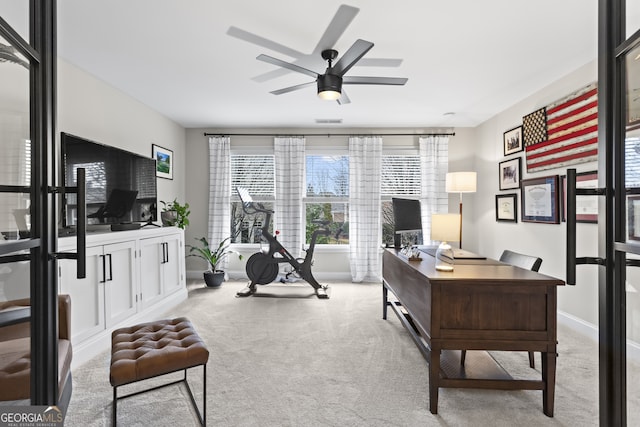 office space featuring carpet, visible vents, baseboards, and ceiling fan