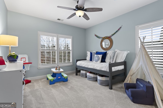 bedroom with visible vents, baseboards, ceiling fan, and carpet flooring