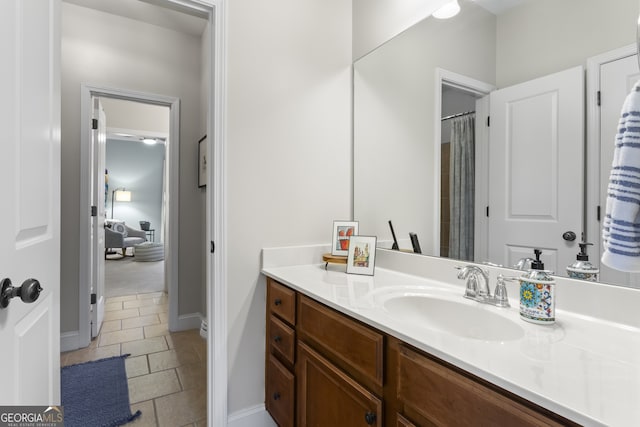 full bathroom featuring vanity and baseboards