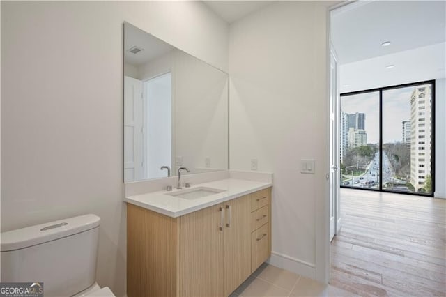 2425 Peachtree Rd NE Unit 903, Atlanta, GA 30305 - half bath featuring vanity, baseboards, visible vents, a city view, and toilet