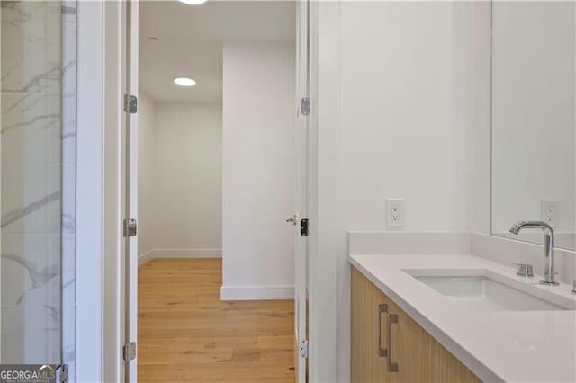 2425 Peachtree Rd NE Unit 903, Atlanta, GA 30305 - bathroom featuring vanity, wood finished floors, and baseboards