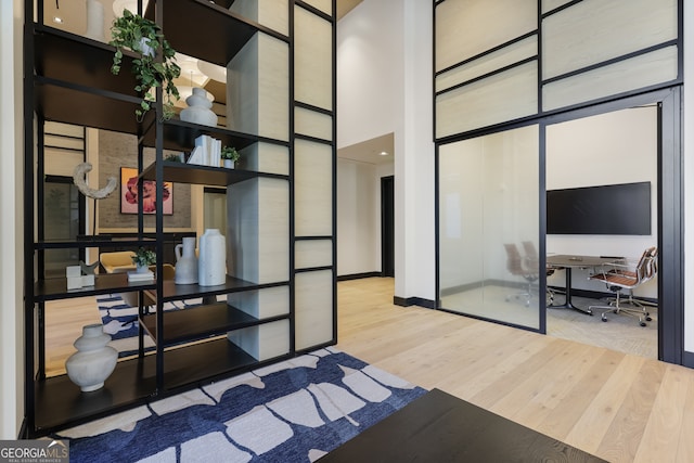 2425 Peachtree Rd NE Unit 903, Atlanta, GA 30305 - bedroom featuring a high ceiling, wood finished floors, and baseboards