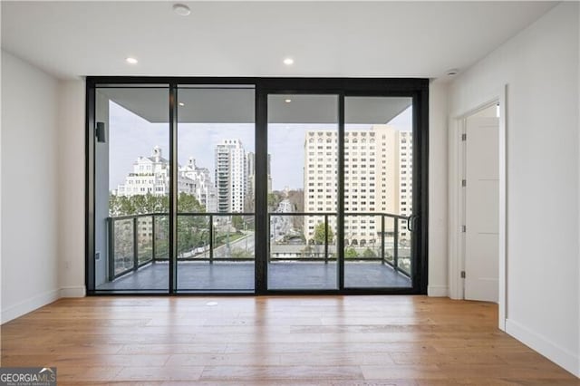 2425 Peachtree Rd NE Unit 903, Atlanta, GA 30305 - entryway featuring baseboards, a city view, wood finished floors, and floor to ceiling windows