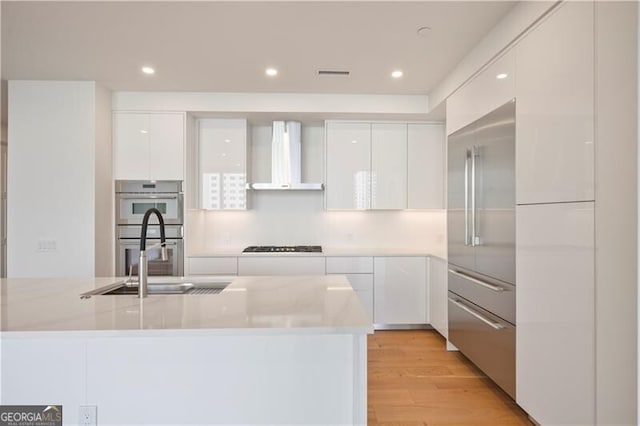 2425 Peachtree Rd NE Unit 903, Atlanta, GA 30305 - kitchen featuring white cabinetry, modern cabinets, wall chimney exhaust hood, and a sink
