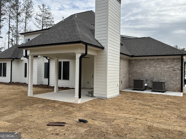 back of house with a patio, a chimney, cooling unit, and a ceiling fan