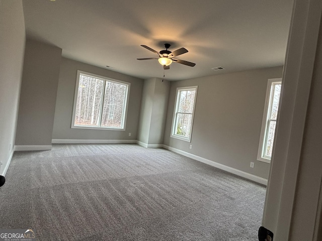 empty room featuring baseboards, visible vents, ceiling fan, and carpet flooring