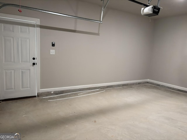 garage featuring baseboards and a garage door opener