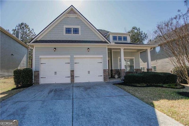 craftsman house featuring driveway, a garage, and a porch