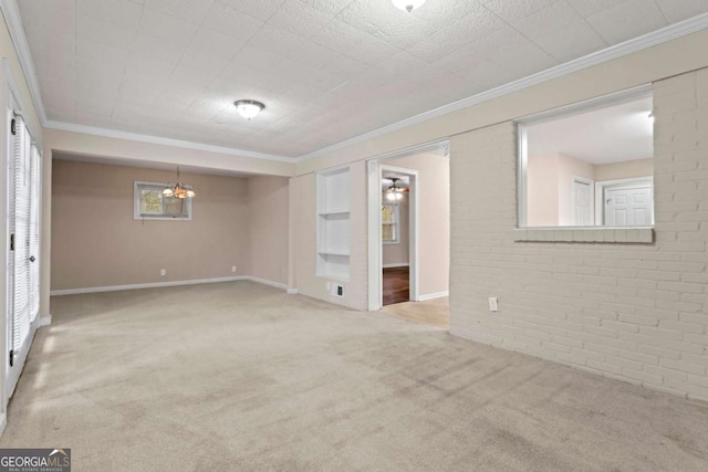 unfurnished room with light carpet, brick wall, baseboards, and crown molding