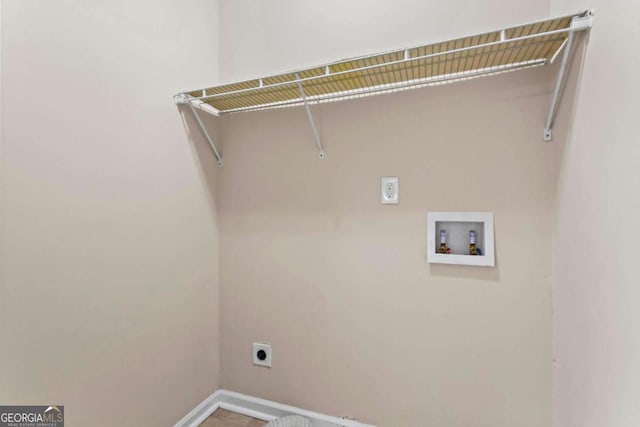 laundry room featuring laundry area, hookup for a washing machine, baseboards, and electric dryer hookup