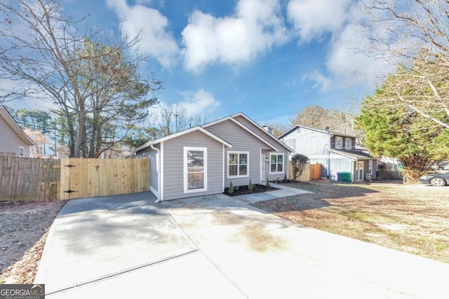 bungalow-style home featuring fence