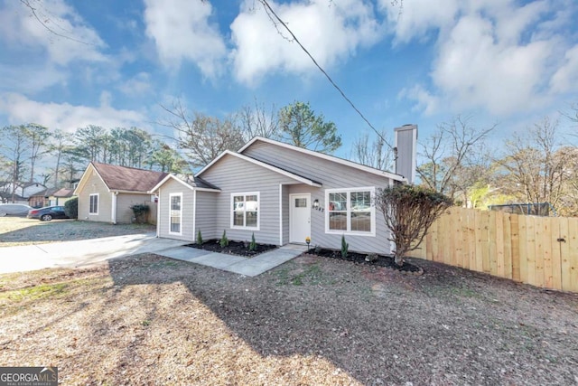 view of front of property with fence and a chimney