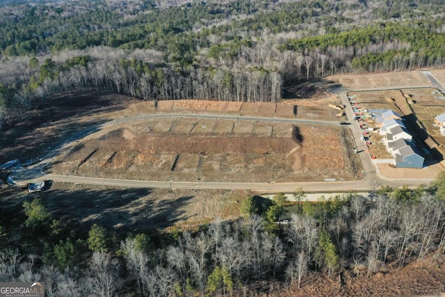 birds eye view of property with a view of trees