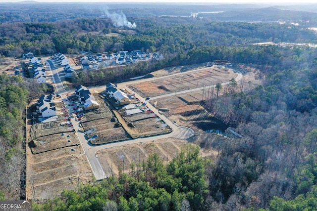 birds eye view of property with a forest view