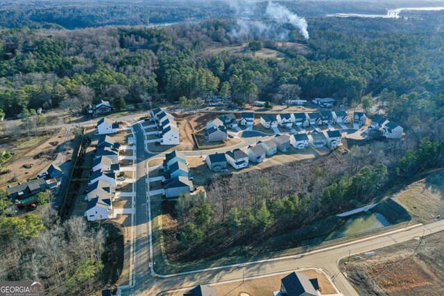 bird's eye view featuring a forest view and a residential view