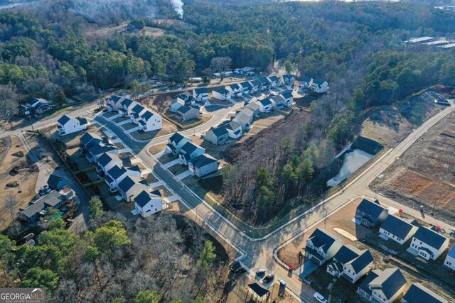 birds eye view of property with a forest view and a residential view