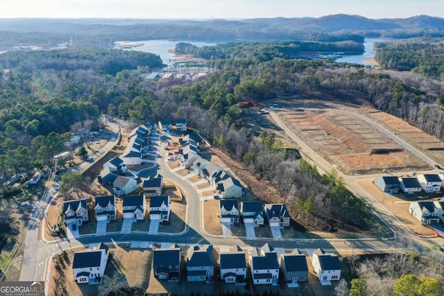 drone / aerial view with a water view and a residential view