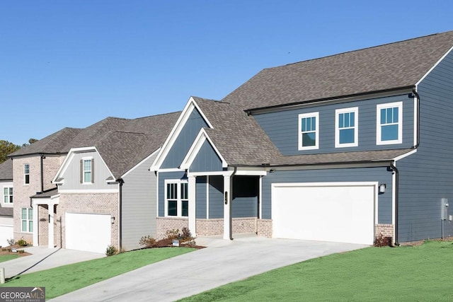 view of front facade featuring a garage, brick siding, driveway, roof with shingles, and a front yard