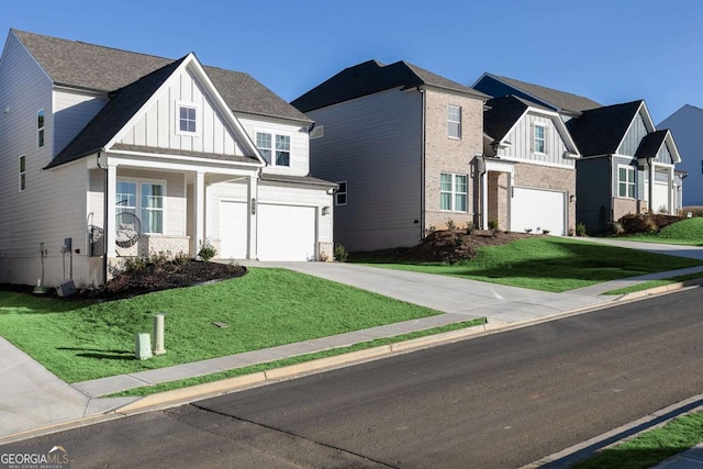 view of front of property featuring concrete driveway, board and batten siding, a front yard, a garage, and a residential view