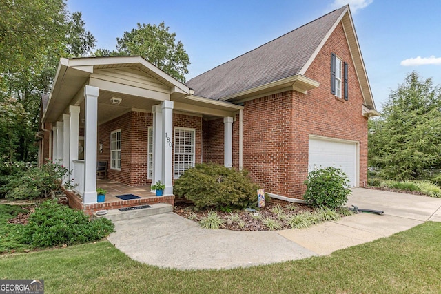 view of front of house featuring brick siding, roof with shingles, covered porch, concrete driveway, and a garage