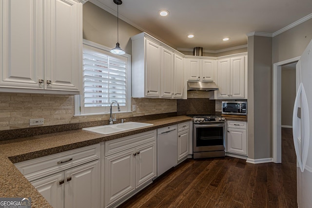 kitchen with dark countertops, appliances with stainless steel finishes, under cabinet range hood, white cabinetry, and a sink