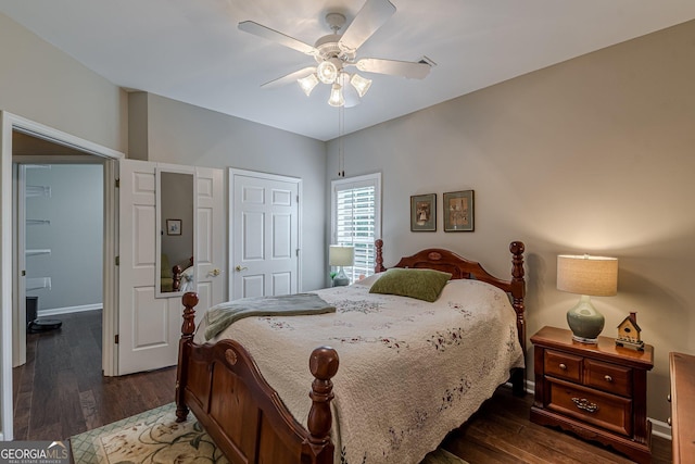 bedroom with baseboards, dark wood finished floors, and a ceiling fan