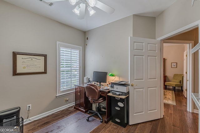 office space with dark wood-type flooring, a ceiling fan, visible vents, and baseboards