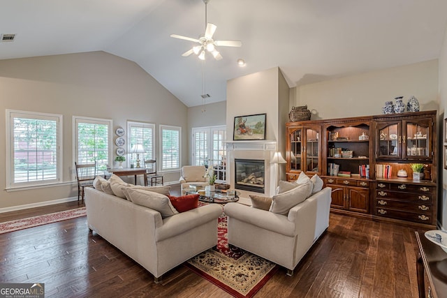 living room with visible vents, high vaulted ceiling, dark wood-style flooring, and a high end fireplace