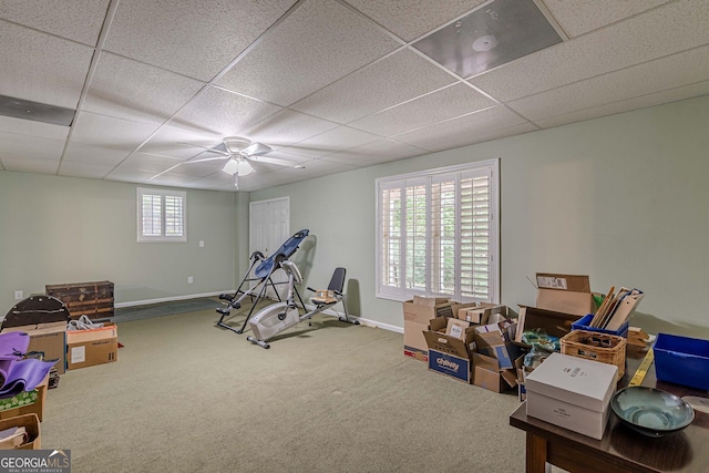 workout area featuring baseboards, carpet flooring, and a drop ceiling