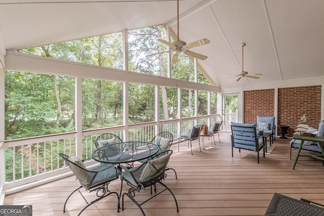 sunroom / solarium featuring lofted ceiling and a ceiling fan