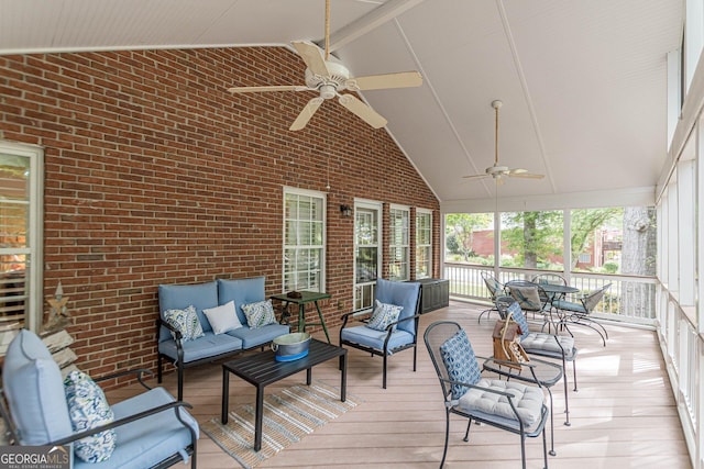 sunroom / solarium with vaulted ceiling and a ceiling fan