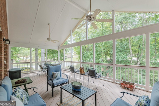 sunroom with lofted ceiling with beams and ceiling fan