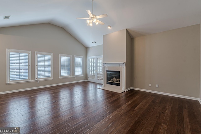 unfurnished living room featuring dark wood-style flooring, visible vents, a premium fireplace, a ceiling fan, and baseboards