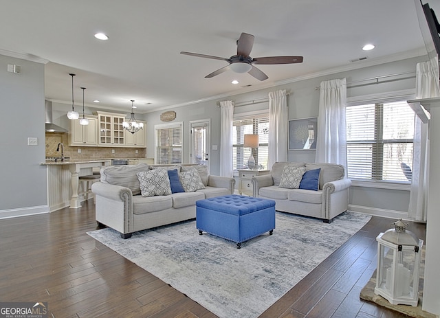 living area featuring ornamental molding, baseboards, and dark wood-style floors