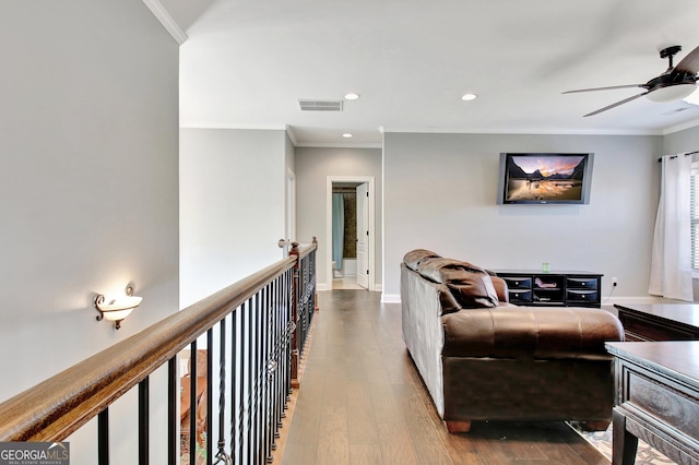 living area featuring recessed lighting, dark wood-style flooring, visible vents, baseboards, and crown molding