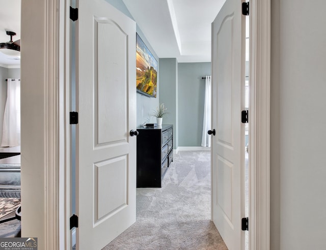 corridor with light carpet and baseboards