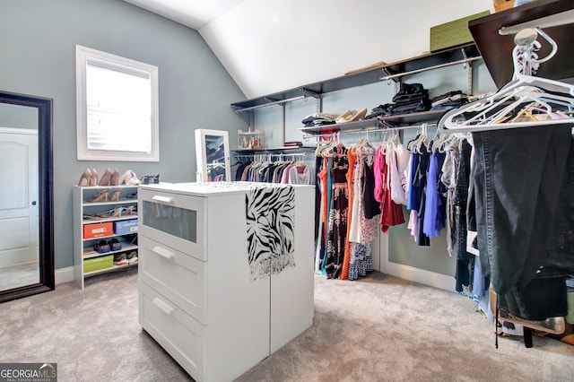 spacious closet featuring light carpet and vaulted ceiling