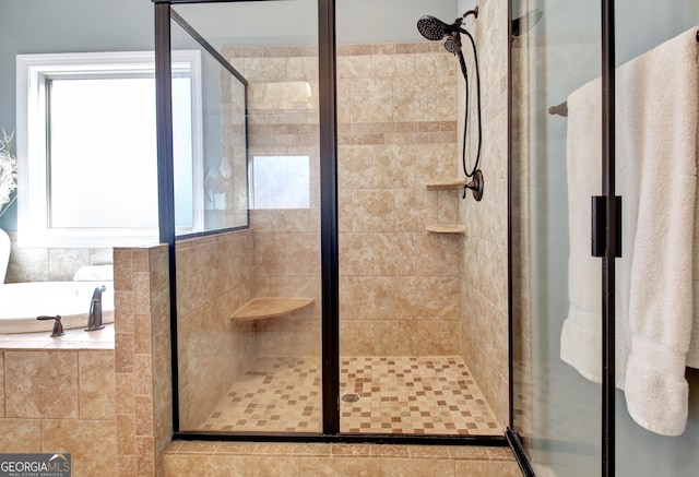 bathroom with a garden tub and a shower stall