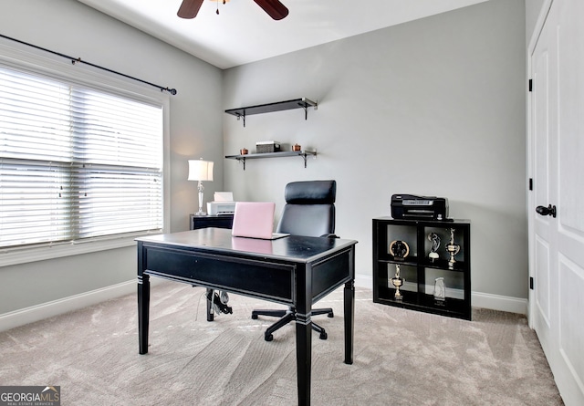 carpeted office featuring ceiling fan and baseboards