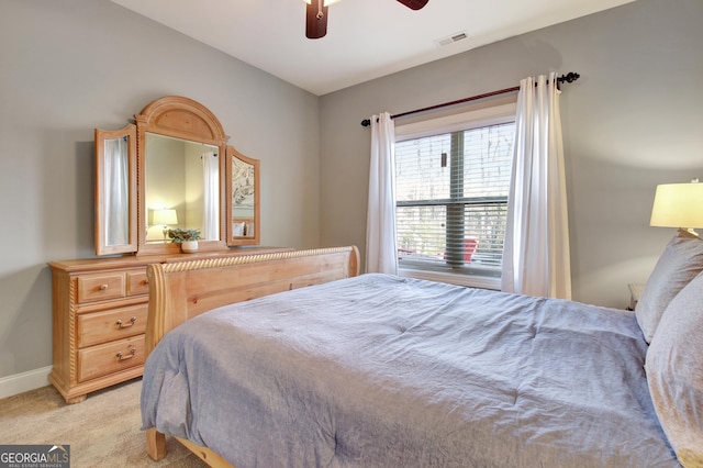 bedroom featuring baseboards, ceiling fan, visible vents, and light colored carpet