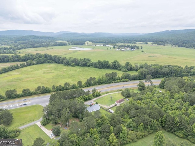 birds eye view of property with a mountain view and a rural view