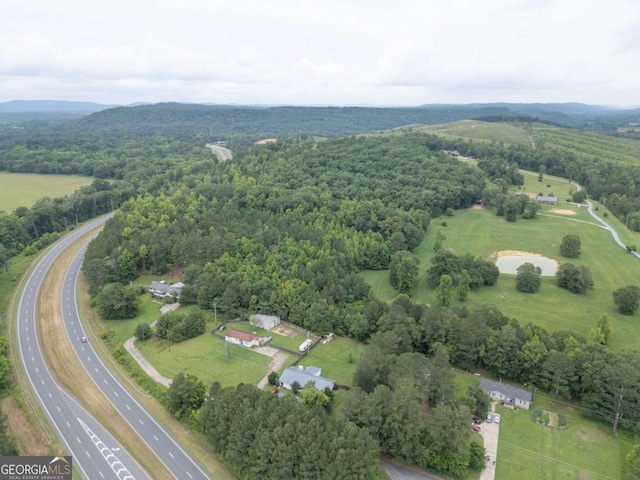 bird's eye view with a wooded view