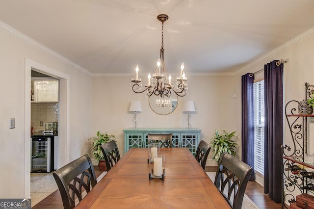 dining space with ornamental molding, wine cooler, and a chandelier