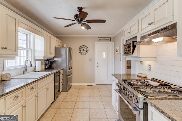 kitchen featuring light tile patterned flooring, under cabinet range hood, a sink, ornamental molding, and gas stove