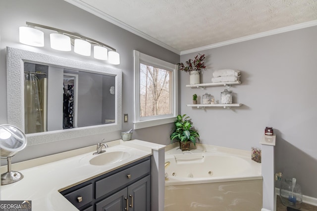 full bath featuring a textured ceiling, ornamental molding, a jetted tub, and vanity