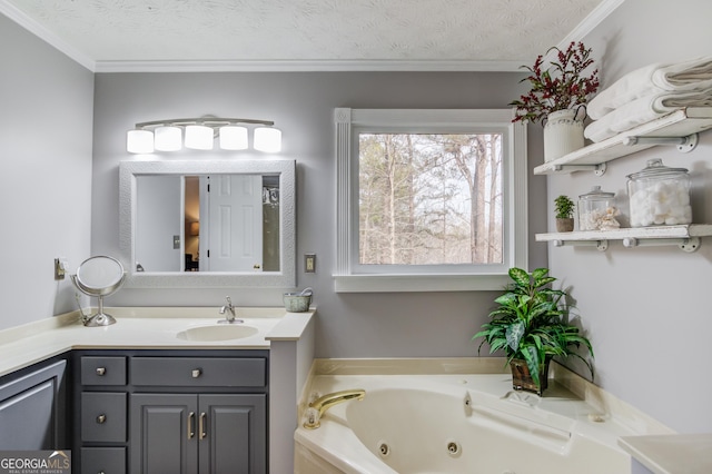 full bath with a jetted tub, ornamental molding, a textured ceiling, and vanity